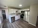 The kitchen features stainless steel appliances, white cabinetry, and modern lighting fixtures, creating a sleek design at 7641 E 35Th St, Indianapolis, IN 46226