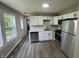 Bright kitchen featuring stainless steel appliances, white cabinets, and modern design, illuminated by ample natural light at 7641 E 35Th St, Indianapolis, IN 46226