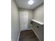Functional laundry room featuring a storage shelf and closet space for organization at 7641 E 35Th St, Indianapolis, IN 46226