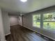 Bright living space featuring dark flooring, neutral walls, and modern lighting, enhanced by natural light streaming through large windows at 7641 E 35Th St, Indianapolis, IN 46226