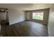 The home's interior showcases a modern living space with dark flooring, freshly painted walls, and plenty of natural light at 7641 E 35Th St, Indianapolis, IN 46226
