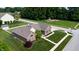 Aerial view of a brick home showcasing its manicured lawn, mature trees, and nearby playground at 8028 Meadow Bend Ln, Indianapolis, IN 46259