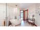 Bathroom features a soaking tub, standing shower, and decorative lighting at 8028 Meadow Bend Ln, Indianapolis, IN 46259