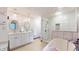 Bathroom features a soaking tub, standing shower, and dual sink vanity with decorative lighting at 8028 Meadow Bend Ln, Indianapolis, IN 46259