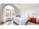 Bedroom features arched window, soft carpet and a white comforter at 8028 Meadow Bend Ln, Indianapolis, IN 46259