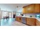 Bright and airy kitchen with stainless steel appliances, wood cabinets, and a seamless flow to dining area at 8028 Meadow Bend Ln, Indianapolis, IN 46259