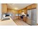 Well-equipped kitchen featuring wood cabinets, stainless steel appliances, and ample countertop space at 8028 Meadow Bend Ln, Indianapolis, IN 46259