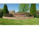 Attractive brick neighborhood sign with lush landscaping, creating a welcoming entrance at 8028 Meadow Bend Ln, Indianapolis, IN 46259