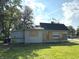 Exterior view of a one-story home featuring light-colored siding and black shingle roof at 827 W 9Th St, Anderson, IN 46016