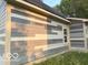 Exterior shot of a light-colored house with light trim and new windows at 827 W 9Th St, Anderson, IN 46016