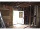 A room under construction, showcasing exposed framing and an open doorway, highlighting potential transformation at 827 W 9Th St, Anderson, IN 46016