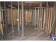 View of an unfinished room featuring exposed framing, wiring, and rough flooring at 827 W 9Th St, Anderson, IN 46016