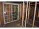 View of an unfinished room featuring exposed framing, new sliding glass door, and rough flooring at 827 W 9Th St, Anderson, IN 46016