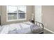 A bright bedroom featuring a bed near the window and a door at 851 Sonoma Ln, Greenfield, IN 46140