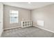 A carpeted bedroom with a storage cube, a window with blinds and white walls at 851 Sonoma Ln, Greenfield, IN 46140