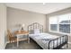 A cozy bedroom featuring a bed, a window, a desk and a comfortable chair at 851 Sonoma Ln, Greenfield, IN 46140