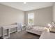 This bedroom has a twin bed, a desk and storage shelves, and a window for natural light at 851 Sonoma Ln, Greenfield, IN 46140