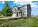A beautiful two-story home with gray siding, white trim, a lush green lawn, and mature landscaping at 851 Sonoma Ln, Greenfield, IN 46140