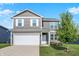 Charming two-story home with gray siding, white trim, attached two car garage, and well-maintained landscaping at 851 Sonoma Ln, Greenfield, IN 46140