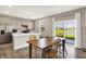 Open-concept kitchen flows into dining area, featuring stainless appliances, light gray cabinets, and backyard view at 851 Sonoma Ln, Greenfield, IN 46140