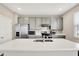 Bright kitchen features stainless steel appliances, light gray cabinets, and a center island with a sink at 851 Sonoma Ln, Greenfield, IN 46140