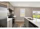 Clean kitchen features stainless steel appliances, sleek gray cabinets, and a center island with modern countertops at 851 Sonoma Ln, Greenfield, IN 46140