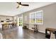 Open-concept living room featuring wood floors, a ceiling fan, and a view to the backyard at 851 Sonoma Ln, Greenfield, IN 46140