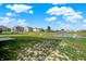 A serene pond is located within the community, with houses and a playground in the background at 851 Sonoma Ln, Greenfield, IN 46140