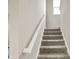 Carpeted staircase with white handrail leads to the upper level, bathed in natural light at 851 Sonoma Ln, Greenfield, IN 46140
