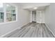 Bedroom featuring light gray walls, gray wood-look floors, and a french door at 91 N Raceway Rd, Indianapolis, IN 46234