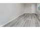 Bright bedroom featuring gray wood-look floors, light gray walls, and ample natural light at 91 N Raceway Rd, Indianapolis, IN 46234