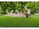 Inviting single-story home showcasing a lush, green lawn, classic facade, and charming front yard at 91 N Raceway Rd, Indianapolis, IN 46234