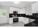 Well-lit kitchen featuring stainless steel appliances and sleek black countertops at 91 N Raceway Rd, Indianapolis, IN 46234