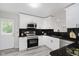Modern kitchen with stainless steel appliances, sleek countertops, and bright white cabinets, ready for cooking at 91 N Raceway Rd, Indianapolis, IN 46234