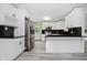 Modern kitchen featuring white cabinets, black countertops, and stainless-steel appliances at 91 N Raceway Rd, Indianapolis, IN 46234