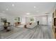 Spacious living area with sleek flooring, comfortable seating, and an abundance of natural light at 91 N Raceway Rd, Indianapolis, IN 46234
