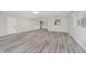 Spacious living room featuring light gray walls, an open layout, and gray wood-look flooring at 91 N Raceway Rd, Indianapolis, IN 46234