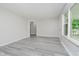 Bright living room with a large window offering natural light and serene views of the outdoors at 91 N Raceway Rd, Indianapolis, IN 46234