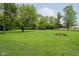 Lush green yard featuring mature trees and ample open space at 91 N Raceway Rd, Indianapolis, IN 46234
