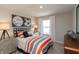 A stylish bedroom features decor, sporty art, and a large window at 921 Shadow Dr, Danville, IN 46122