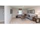 Cozy carpeted living room includes a comfortable sofa, contemporary decor, and a mounted television at 921 Shadow Dr, Danville, IN 46122