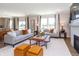 Spacious and bright living room with modern furniture, fireplace, and view to the outside at 921 Shadow Dr, Danville, IN 46122