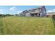 Large backyard featuring a lush green lawn and a covered patio, great for outdoor activities and gatherings at 9671 Ridgecrest Ln, McCordsville, IN 46055