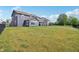 Spacious backyard view showcases a lush green lawn and a view of the home and patio at 9671 Ridgecrest Ln, McCordsville, IN 46055