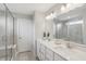 Bathroom featuring double sink vanity, framed mirror, and glass shower at 9671 Ridgecrest Ln, McCordsville, IN 46055