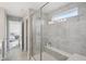 Bright bathroom with glass-enclosed shower and gray tile at 9671 Ridgecrest Ln, McCordsville, IN 46055