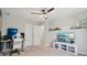 This bedroom features a ceiling fan, carpet floors, shelves, and a television atop a white entertainment center at 9671 Ridgecrest Ln, McCordsville, IN 46055