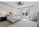 Bright bedroom with tray ceiling, ceiling fan, and windows with a picturesque view at 9671 Ridgecrest Ln, McCordsville, IN 46055