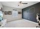 This bedroom offers a dark accent wall featuring an artistic light, window for natural light, and cozy carpet floors at 9671 Ridgecrest Ln, McCordsville, IN 46055