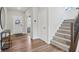 Bright foyer features wood floors, a staircase, and access to the living areas at 9671 Ridgecrest Ln, McCordsville, IN 46055